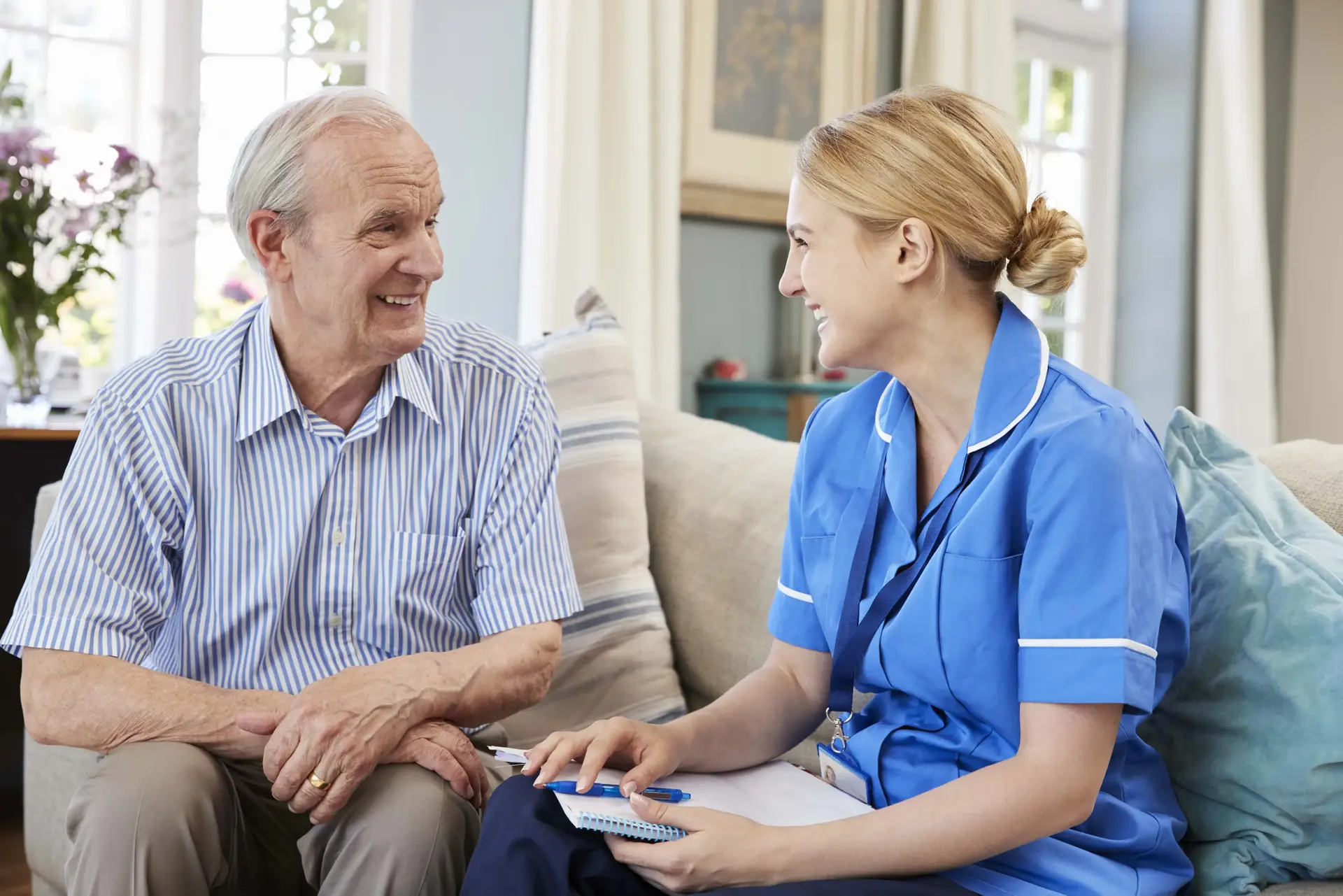 Female community nurse visits senior man at home P352 WCH 1 jpg